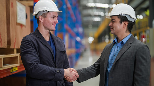 two-men-shaking-hands-in-warehouse
